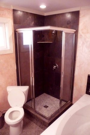 An Early Odd Installation - Stone Tile Shower with Mosaic and Corner Toilet - Tillicum