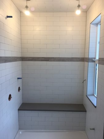 Subway Tile Steam Room Shower with Window, Bench and Stone Accent Band - Fernwood