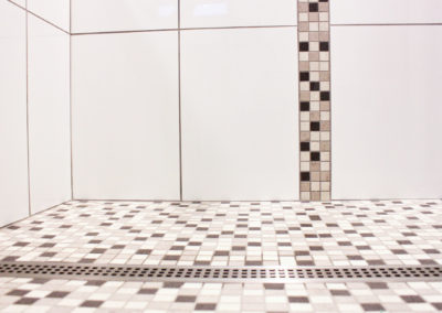 Mosaic Shower Floor With Line Drain and Vertical Tile Accent Band - Oak Bay