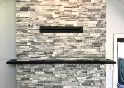 Double Sided Ledgestone Tile Fireplace with Charred Wood Mantle and See-Through Gas Insert with Heat Shift Vent Side 1 - Broadmead