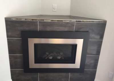 Corner Fireplace with Glass Mosaic Tile Accent Band, Schluter Rondec and Gas Insert - Dean Park