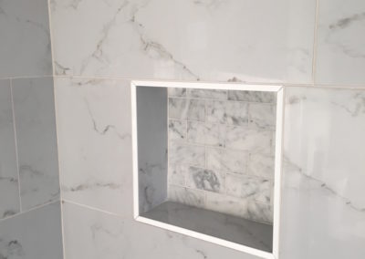 White Tile Walk In Shower with Black Floor and Niche Box Detail - Monterey