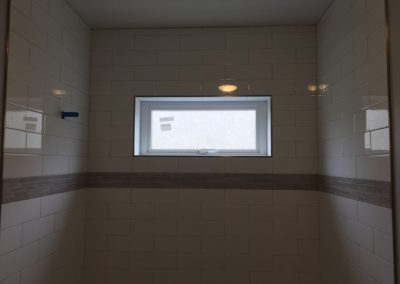 Subway Tile Shower with Window, Stone Accent Band - Fernwood