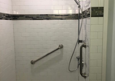 Subway Tile Shower with Glass Mosaic Tile Accent Band and Grab Bar - Brentwood